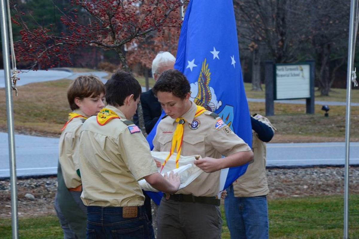 Boy Scouts lower the Flags