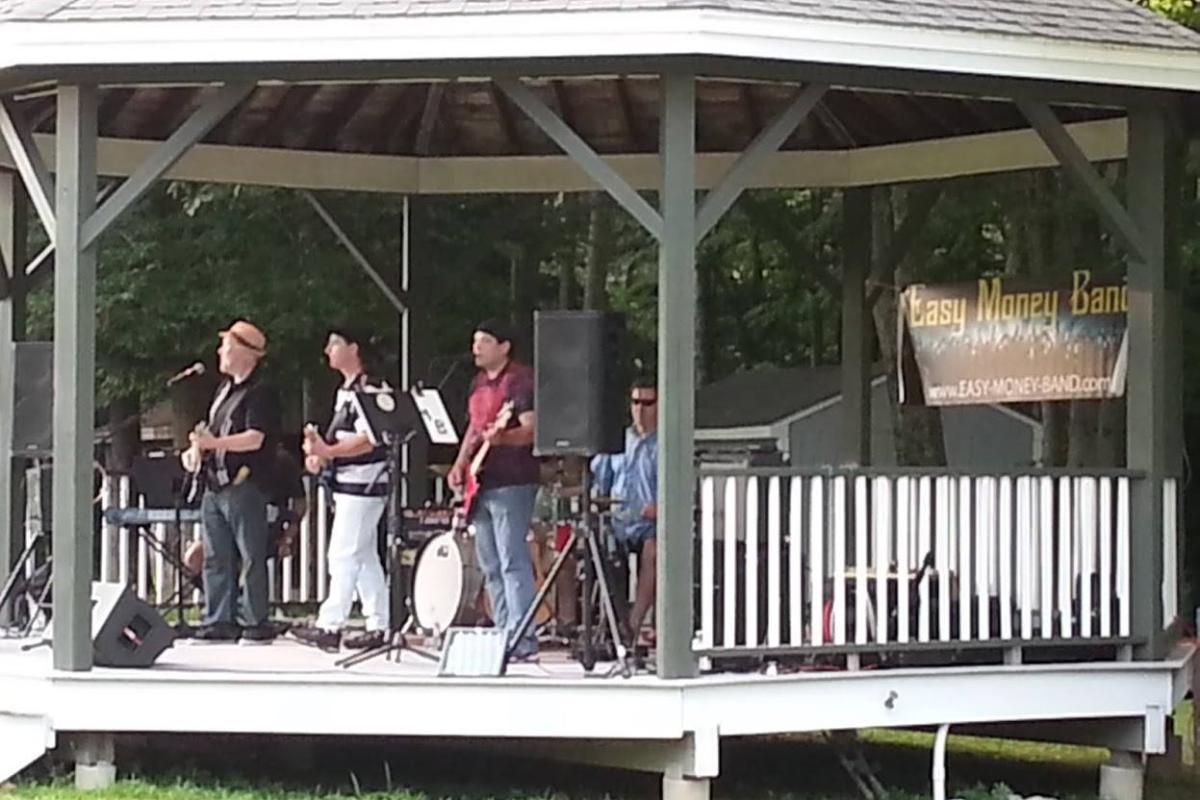 The Easy Money band perform on the Village Green