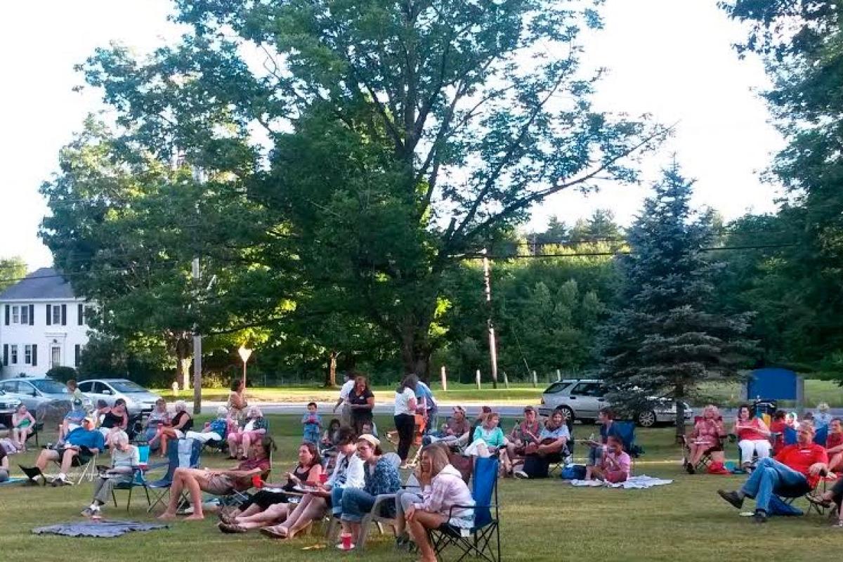 Many people bring picnics to the summer concerts